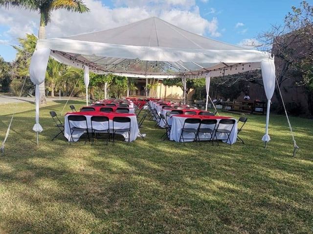 Toldo en jardín con mesas mantel rojo