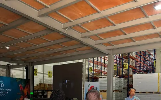 Montaje de un evento de empresa en una bodega con mesas cocteleras